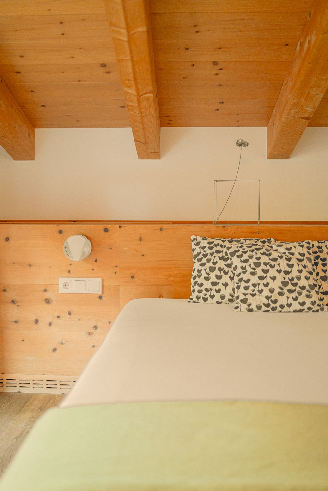 Ein gemütliches Zimmer im Glemmtalerhof in Hinterglemm mit Holzdetails und einem einladenden Bett.
